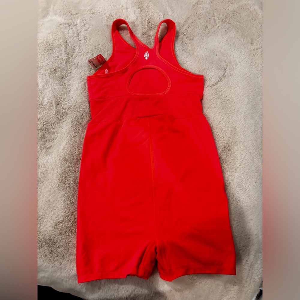Size m free people romper in the color neon coral